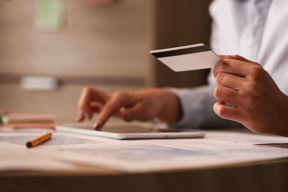 close up businesswoman with credit card checking her bank account digital tablet scaled e1705165876854