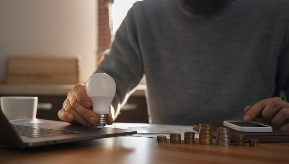 man saving money energy crisis