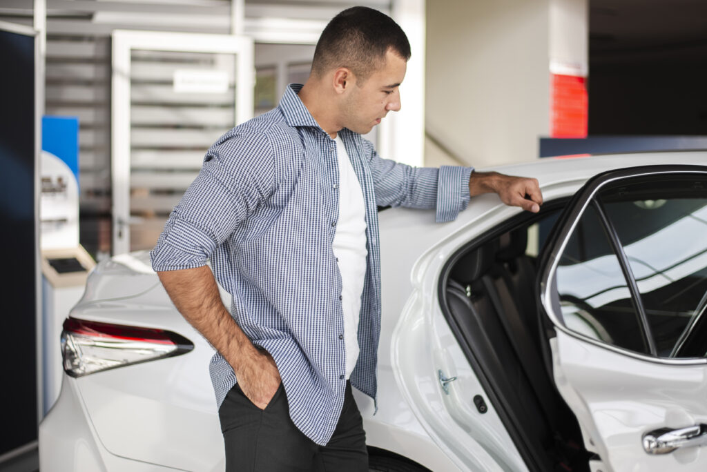 elegant man checking car dealership