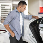 elegant man checking car dealership