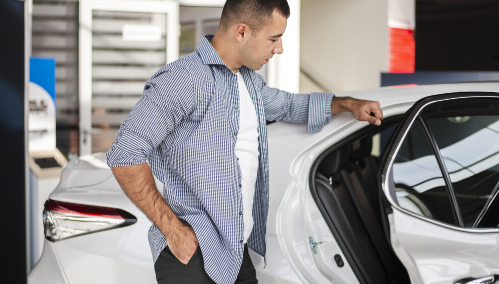 elegant man checking car dealership